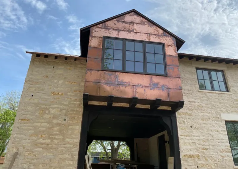 Copper metal panel facade on a stone building for Roof Repair in Tempe