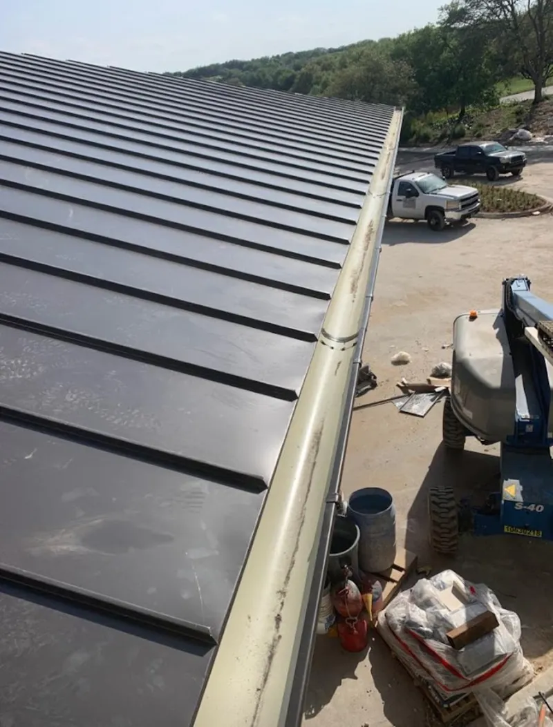 Standing seam panel and gutter detail on a metal roofing jobsite in Tempe